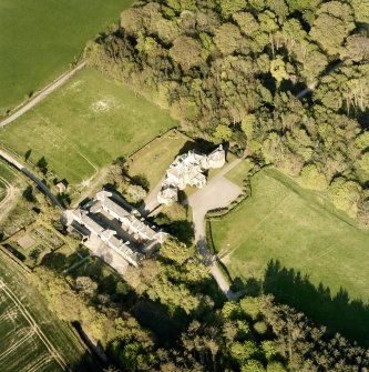 Oblique aerial view centred on the country house and stables, taken from the WSW.