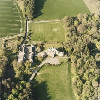 Oblique aerial view centred on the country house and stables, taken from the SW.