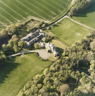 Oblique aerial view centred on the country house and stables, taken from the SSE.