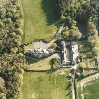 Oblique aerial view centred on the country house and stables, taken from the NE.