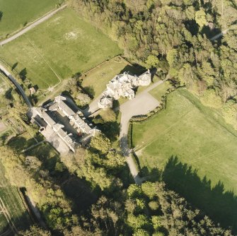 Oblique aerial view centred on the country house and stables, taken from the WSW.