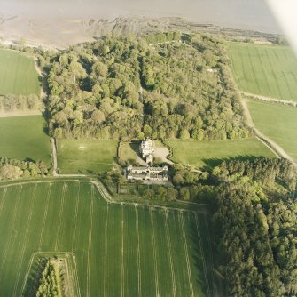 Oblique aerial view centred on the country house, stables, gardens and walled garden, taken from the WNW.
