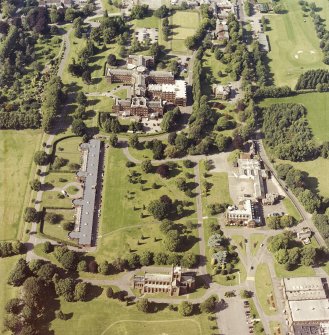 Oblique aerial view centred on the hospital and the church, taken from the SW.