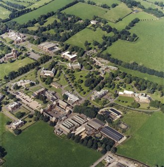 Oblique aerial view centred on the hospital and the church, taken from the SSW.