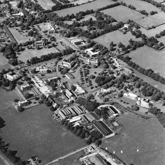Oblique aerial view centred on the hospital and the church, taken from the S.