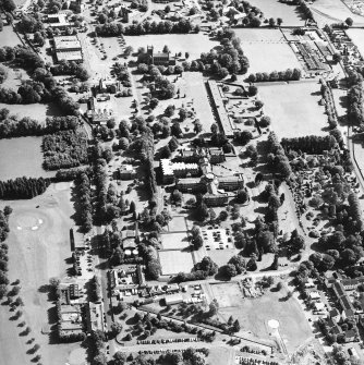 Oblique aerial view centred on the hospital and the church, taken from the NNW.