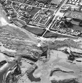 Oblique aerial view centred on the lighthouse with village adjacent, taken from the ESE.