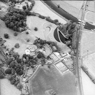 Oblique aerial view centred on the country house and garden, taken from the SE.