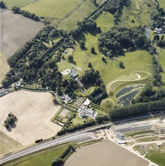 Oblique aerial view centred on the country house and garden with the lodge adjacent, taken from the ENE.