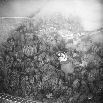 Oblique aerial view centred on country house from SW.