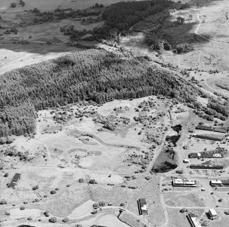 Oblique aerial view centred on part of Unit 1 of the explosives works and armament depot showing the associated earthworks to the N, taken from the W.