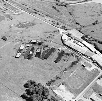 Oblique aerial view centred on Unit 2 of the explosives works and armament depot showing the production houses and loading bank, taken from the NW.