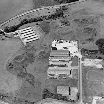 Oblique aerial view centred on Unit 2 of the explosves works and armament depot, showing the earthworks for burette houses and charge houses taken from the SSE.
Also visible is Edingham Industrial estate with Edingham farm poultry houses.