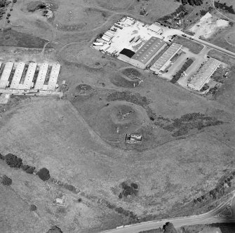 Oblique aerial view centred on Unit 2 of the explosives works and armament depot, showing the earthworks for the charge houses taken from the S.
Also visible is Edingham Castle, Edingham Industrial Estate with Edingham farm poultry houses.