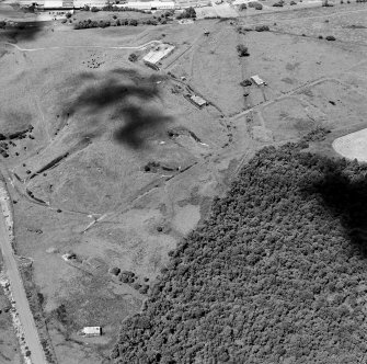 Oblique aerial view centred on the S part of the explosives works and armament depot showing the magazine area with earthworks for internal tranway system from the SE.
