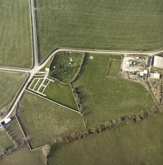 Oblique aerial view centred on the remains of the church and burial-ground, taken from the SSW.