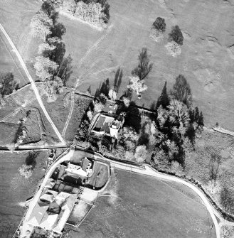 Oblique aerial view centred on the tower-house with farmsteading adjacent, taken from the WSW.