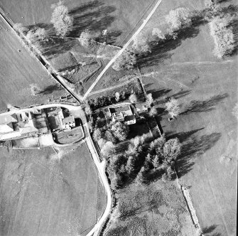 Oblique aerial view centred on the tower-house with farmsteading adjacent, taken from the SW.