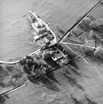 Oblique aerial view centred on the tower-house with farmsteading adjacent, taken from the ESE.