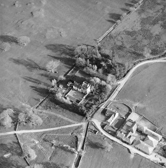 Oblique aerial view centred on the tower-house with farmsteading adjacent, taken from the NNW.