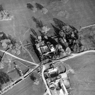 Oblique aerial view centred on the tower-house with farmsteading adjacent, taken from the NW.