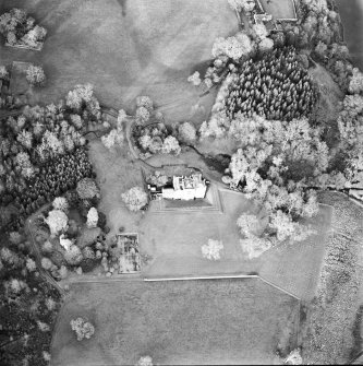 Oblique aerial view centred on the country house with tower-house and garden adjacent, taken from the S.