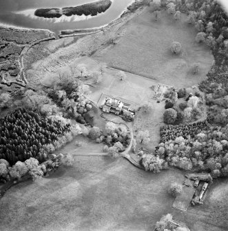 Oblique aerial view centred on the country house with tower-house and garden adjacent, taken from the NNW.
