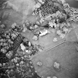 Oblique aerial view centred on the country house with tower-house and garden adjacent, taken from the SW.