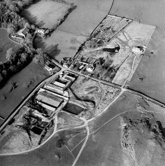 Oblique aerial view centred on the farmsteading with church and burial grounds adjacent, taken from the SSW