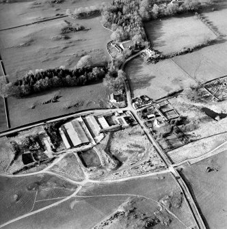 Oblique aerial view centred on the farmsteading with church and burial grounds adjacent, taken from the SSE