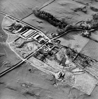 Oblique aerial view centred on the farmsteading with church and burial grounds adjacent, taken from the ESE