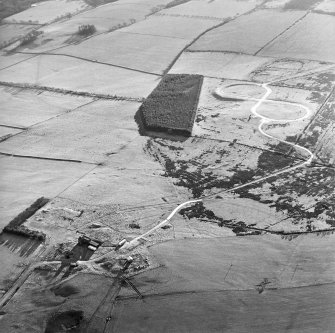 Oblique aerial view of Kirkcudbright training area centred on the firing position and field banks with tank track adjacent, taken from the NW.