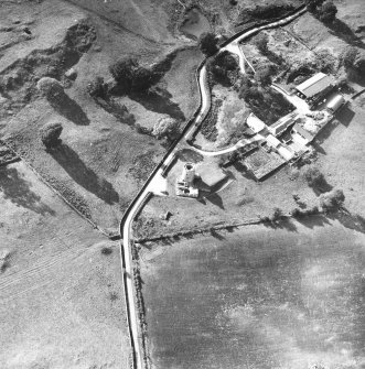 Oblique aerial view centred on tower house from E.