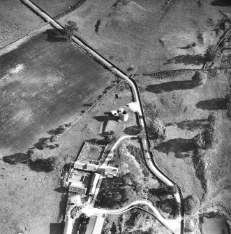 Oblique aerial view centred on tower house from NW.