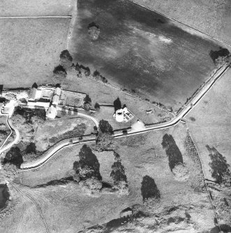 Oblique aerial view centred on tower house from SW.