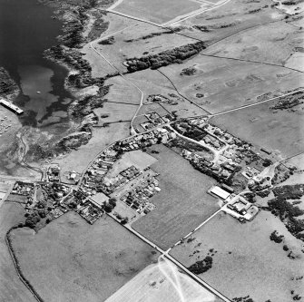 Oblique aerial view from NE, centred on the village.
