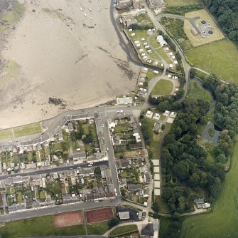 Oblique aerial view of the village, centred on the village hall, taken from the W.