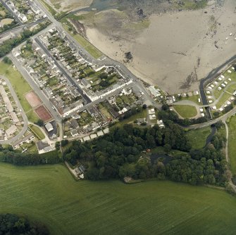 Oblique aerial view of the village, centred on the village hall, taken from the SW.