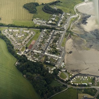 Oblique aerial view of the village, centred on the village hall, taken from the SSE.