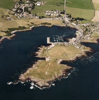 General oblique aerial view centred on the village, harbour, and the remains of the chapel and promontory fort, taken from the ESE.
