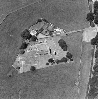 Oblique aerial view centred on the remains of the abbey and abbot¿s house, taken from the SE.