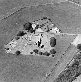 Oblique aerial view centred on the remains of the abbey and abbot¿s house, taken from the ESE.