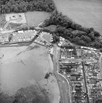 Oblique aerial view of the village, centred on the village hall, taken from the NNW.