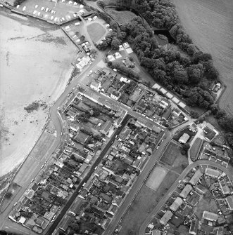 Oblique aerial view of the village, centred on the village hall, taken from the NW.