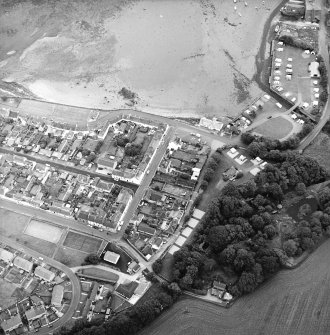 Oblique aerial view of the village, centred on the village hall, taken from the SW.