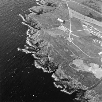 Oblique aerial view centred on the remains of the anti-aircraft battery and buildings with the remains of the promontory fort adjacent, taken from the ESE.