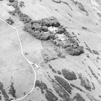 Oblique aerial view centred on the house, taken from the E.