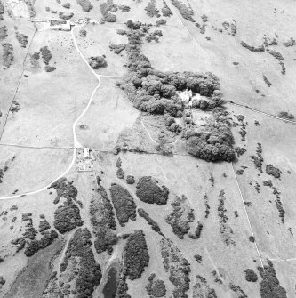 Oblique aerial view centred on the house with the farmsteading adjacent, taken from the ENE