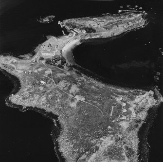 Inchcolm Island, oblique aerial view, taken from the SW, centred on a coast battery, with Inchcolm Abbey and three coastal batteries visible in the background.
