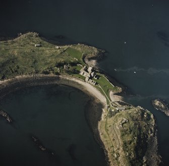 Oblique aerial view centred on the abbey with coast batteries adjacent, taken from the ESE.